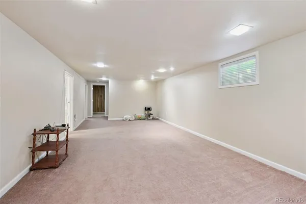 an empty room with furniture and natural light