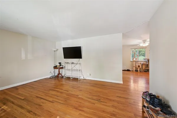 a view of a livingroom with wooden floor and a flat screen tv