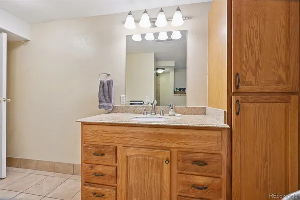 a bathroom with a sink vanity and a mirror