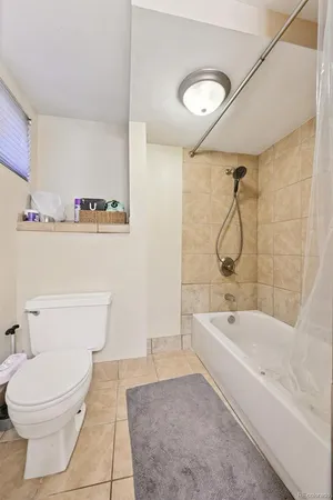 a bathroom with a granite countertop toilet a sink and bathtub