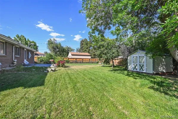 a view of a house with backyard and a sitting area