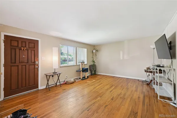 a view of a livingroom with furniture and a flat screen tv