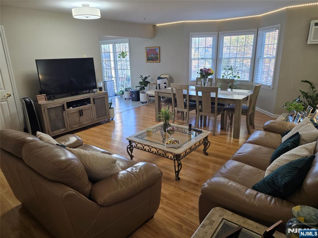 420 Passaic Street, Unit 2G Hackensack, NJ 07601 - Photo 11 of 35 a living room with furniture and a flat screen tv