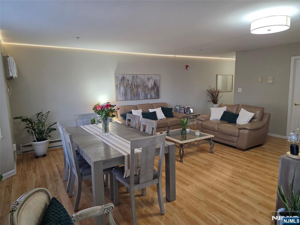 420 Passaic Street, Unit 2G Hackensack, NJ 07601 - Photo 13 of 35 a view of a dining room with furniture and wooden floor