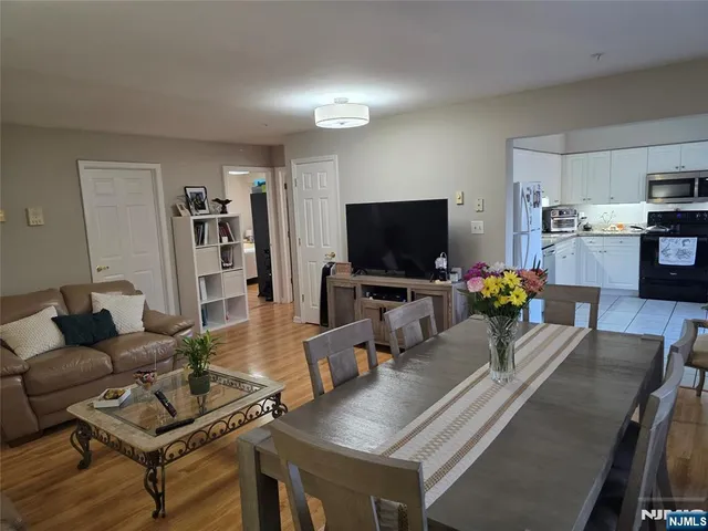 a bedroom with a bed and large windows