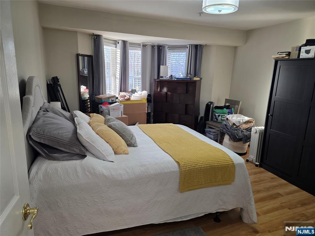 420 Passaic Street, Unit 2G Hackensack, NJ 07601 - Photo 24 of 35 a bedroom with a bed and large windows