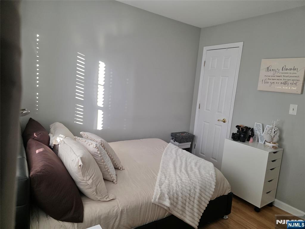 420 Passaic Street, Unit 2G Hackensack, NJ 07601 - Photo 30 of 35 a bedroom with a bed and wooden floor