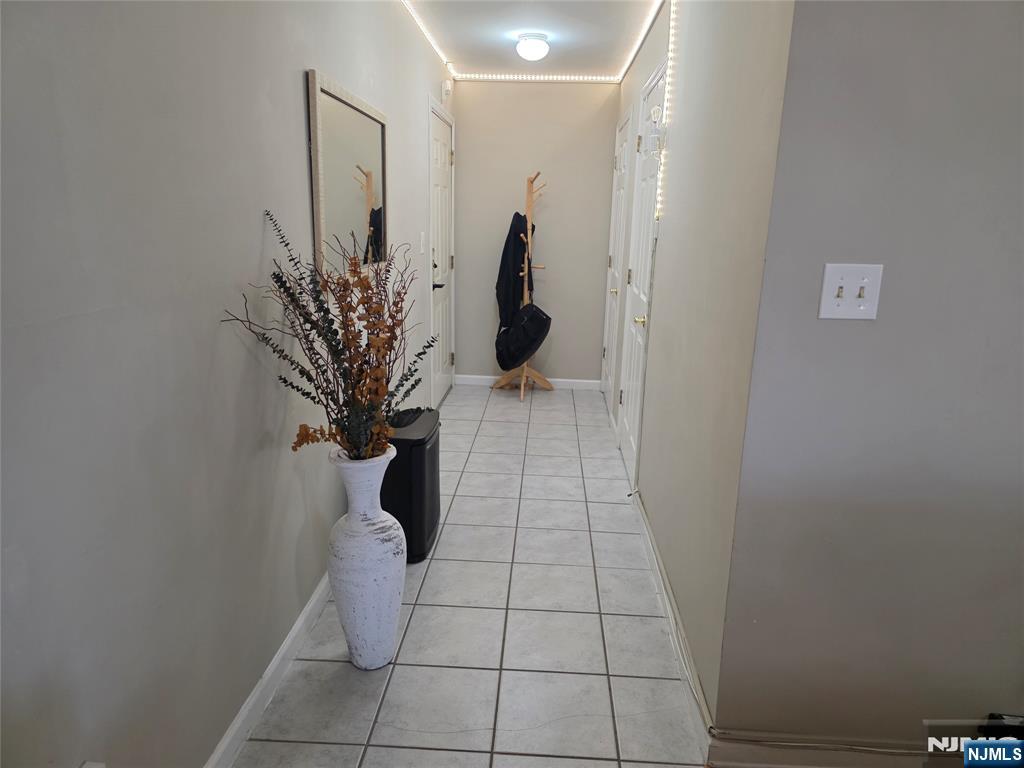 420 Passaic Street, Unit 2G Hackensack, NJ 07601 - Photo 8 of 35 a vase of flowers sitting on a floor in a bathroom