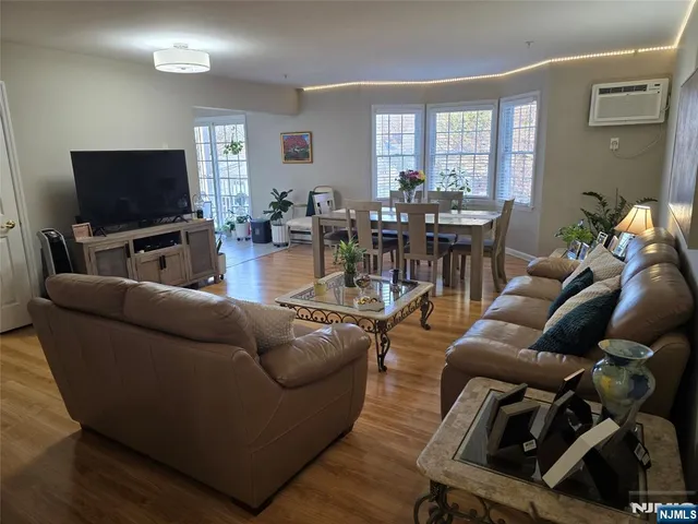 a dining room with furniture and wooden floor
