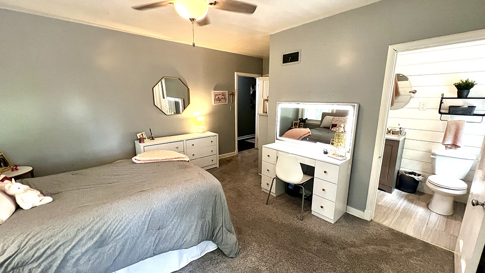 644 Genesee Avenue Morrison, IL 61270 - Photo 22 of 52 a bedroom with a bed and a chandelier
