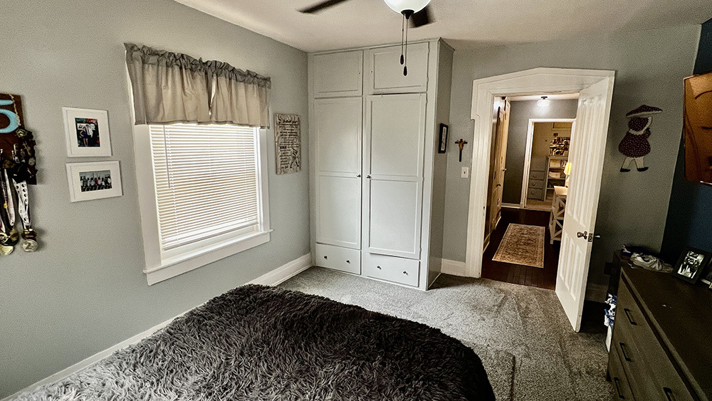 644 Genesee Avenue Morrison, IL 61270 - Photo 29 of 52 a bedroom with a bed and a flat tv screen on the dresser