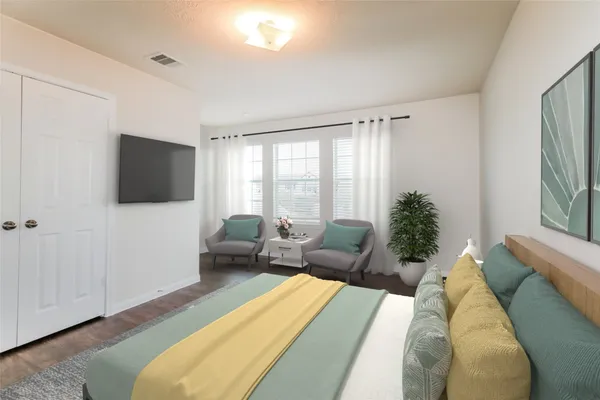 a living room with furniture tv and a window