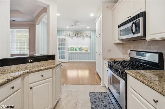 a kitchen with granite countertop a stove and a sink