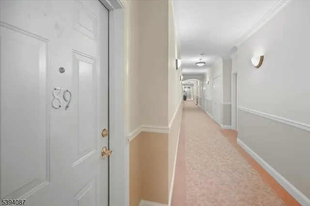 a view of a hallway with wooden floor and glass door