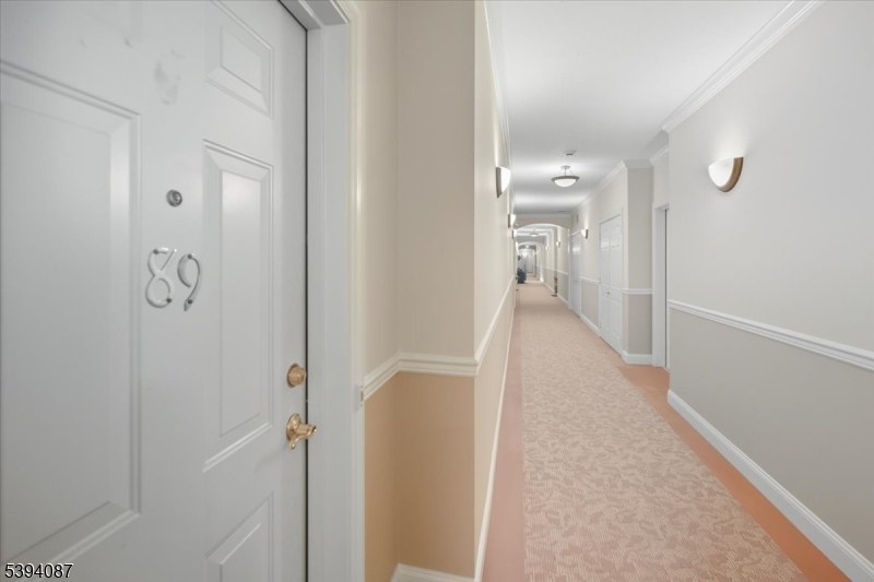 89 Ridgeview Lane, Unit 89 Mount Arlington, NJ 07856 - Photo 2 of 43 a view of a hallway with wooden floor and glass door