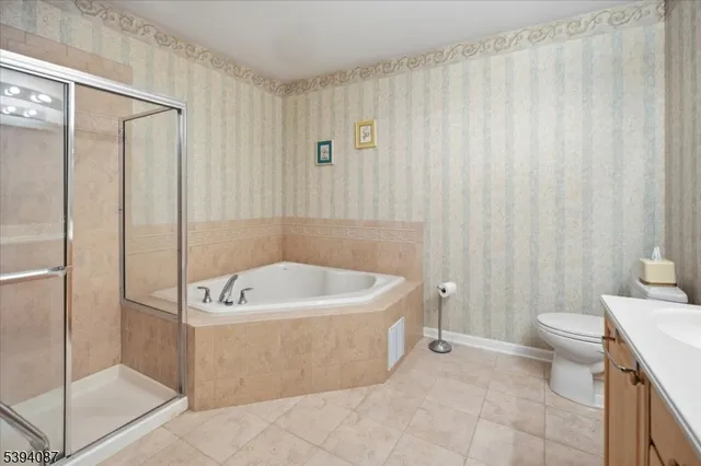 a bath tub sitting next to a white toilet