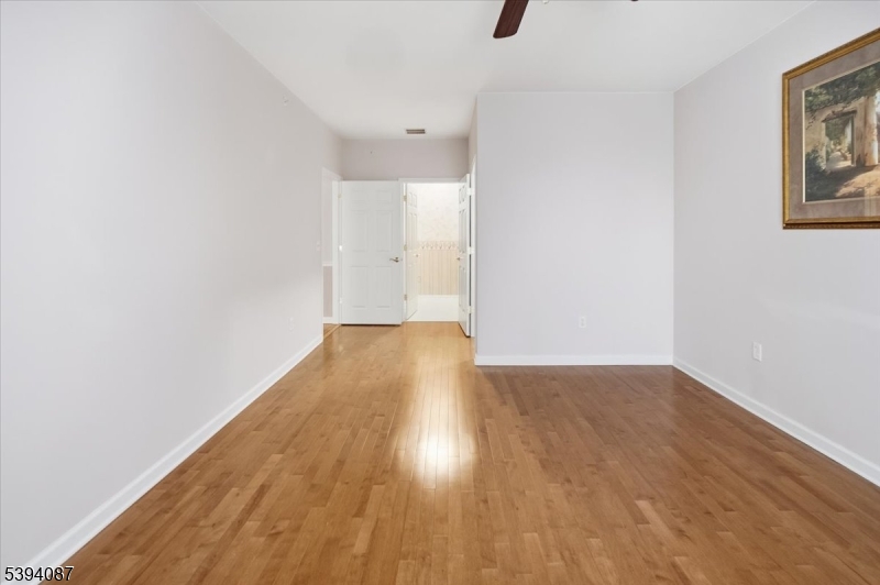 89 Ridgeview Lane, Unit 89 Mount Arlington, NJ 07856 - Photo 27 of 43 a view of empty room with wooden floor