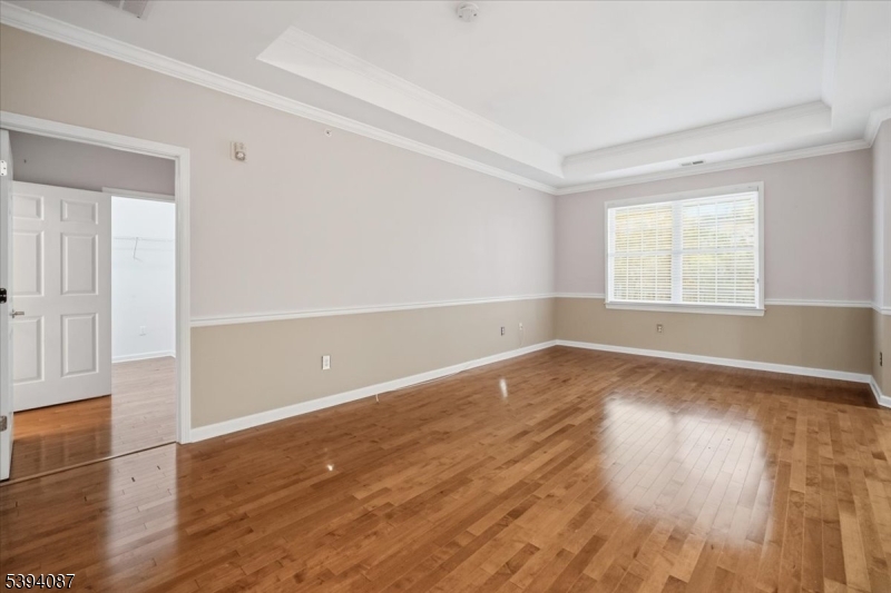 89 Ridgeview Lane, Unit 89 Mount Arlington, NJ 07856 - Photo 6 of 43 an empty room with wooden floor and windows