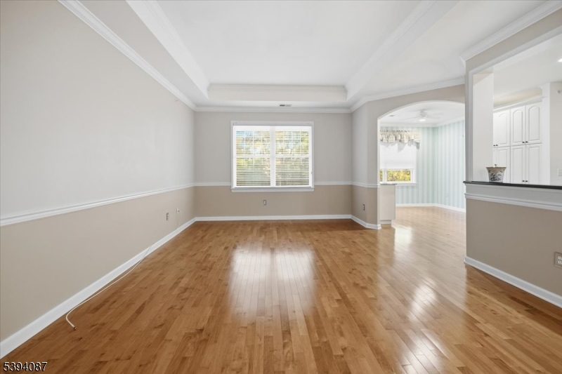 89 Ridgeview Lane, Unit 89 Mount Arlington, NJ 07856 - Photo 7 of 43 an empty room with wooden floor and windows