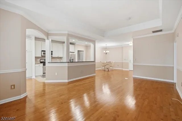 a view of a kitchen with wooden floor and kitchen appliances