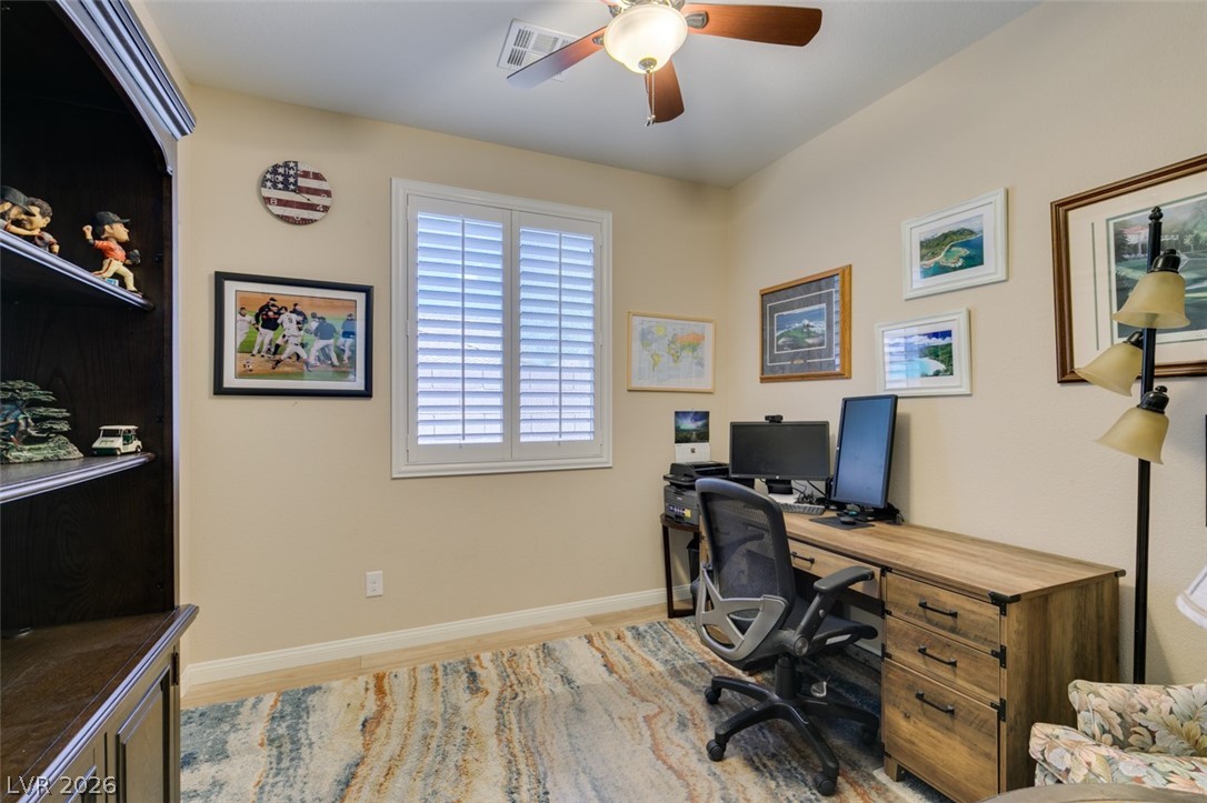7375 Campbell Ranch Avenue Las Vegas, NV 89179 - Photo 28 of 45 A quiet room featuring a wood-style floor, a window with plantation shutters, closet and a ceiling fan for comfort.
