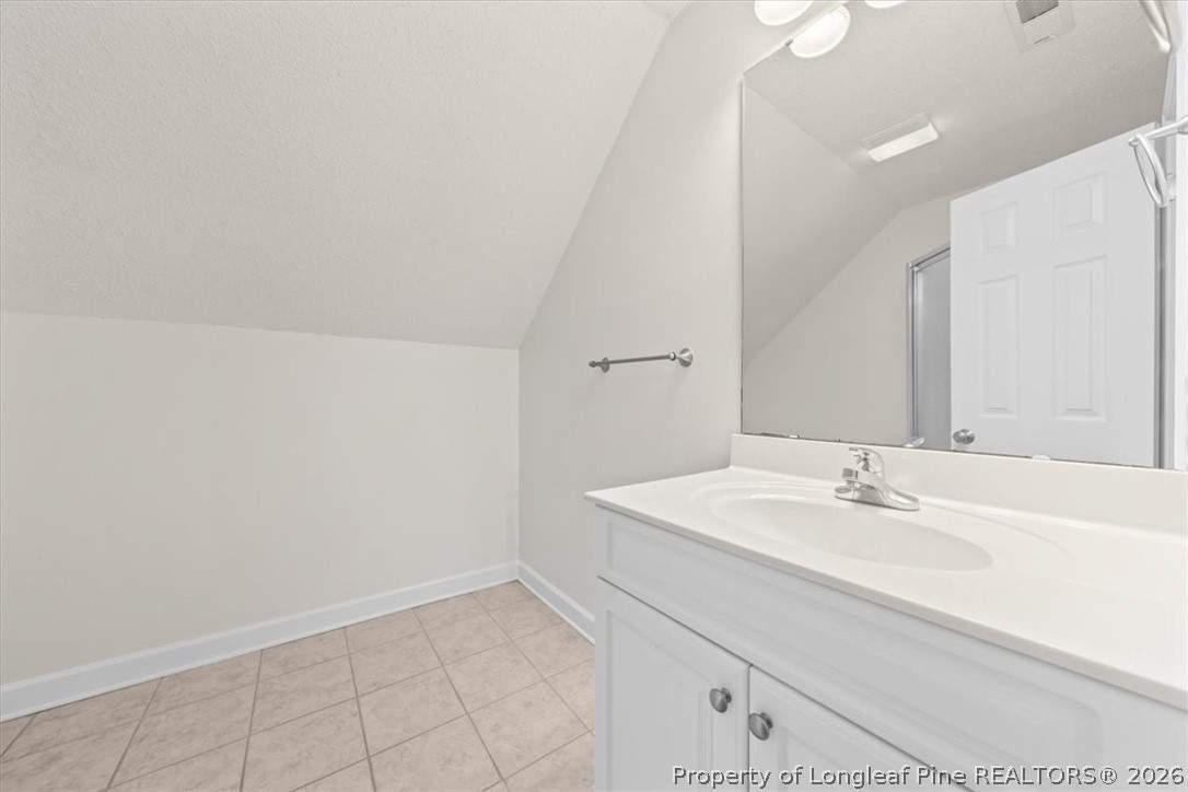 60 Spring Lake Drive Pinehurst, NC 28374 - Photo 27 of 42 a bathroom with a sink and a mirror