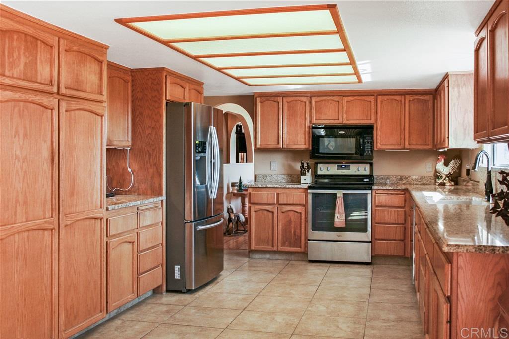 14705 Vesper Road Valley Center, CA 92082 - Photo 12 of 25 Granite counters, porcelain tile floors, and stainless appliances