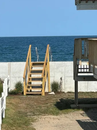 a view of wooden floor with a bench in the background