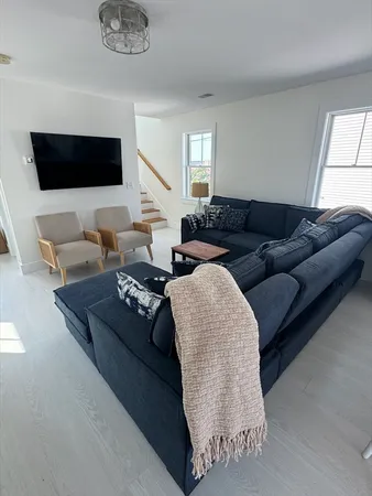 a living room with couches and a flat screen tv