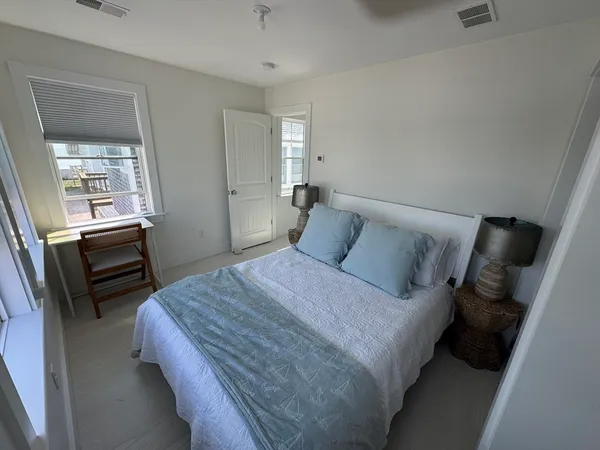 a bedroom with a bed next to a window
