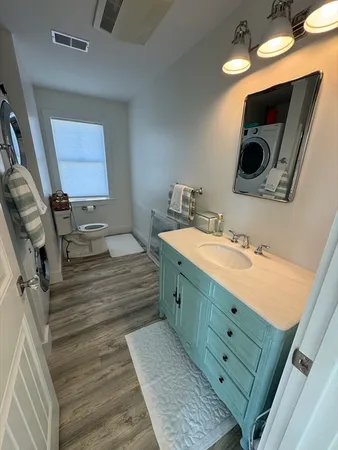 a bathroom with a double vanity sink mirror and bathtub