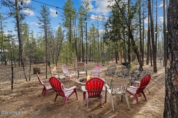 a kitchen with stainless steel appliances granite countertop a stove a sink and a dining table view