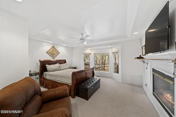 a bed room with a bed and a chandelier