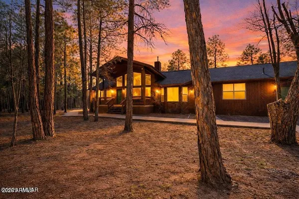 a view of a house with backyard porch and sitting area