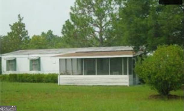 5089 Lynntown Road Collins, GA 30421 - Photo 1 of 1 a view of house with backyard space and balcony