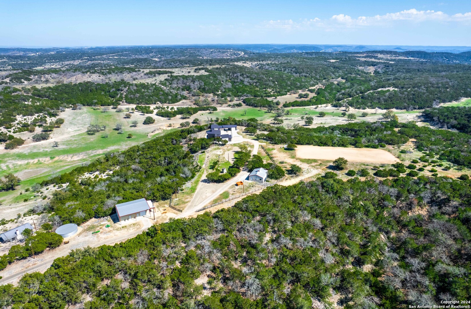 5081 Texas 173 Center Point, TX 78010 - Photo 34 of 61 an aerial view of residential houses with outdoor space and trees