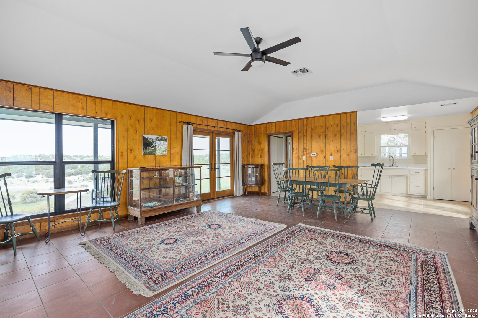 5081 Texas 173 Center Point, TX 78010 - Photo 38 of 61 a living room with furniture a rug wooden floor and a large window
