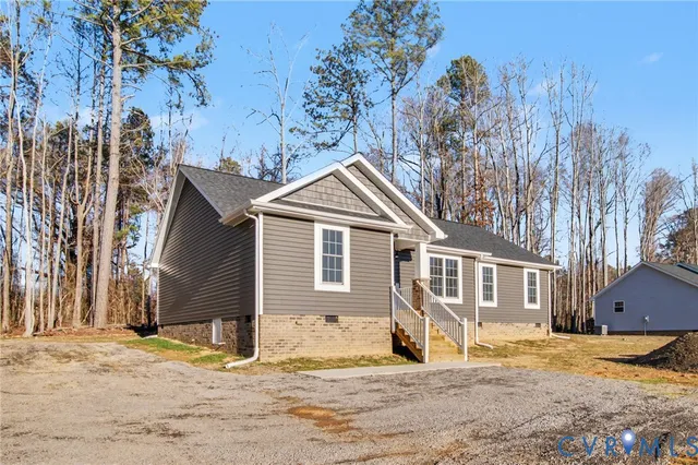 a front view of a house with a yard covered in snow