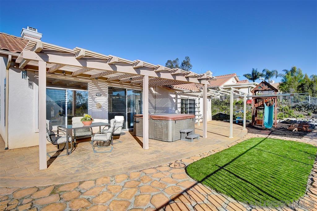 2673 Lobelia Road Alpine, CA 91901 - Photo 8 of 15 a view of a patio with couches table and chairs with wooden floor and fence