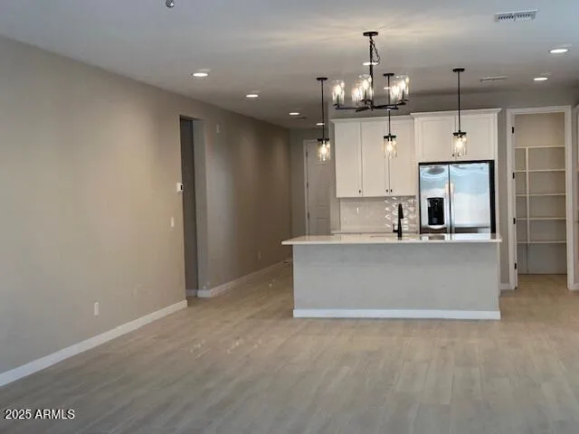 a close view of a stove a microwave and white cabinets
