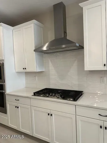 a stove top oven sitting inside of a kitchen