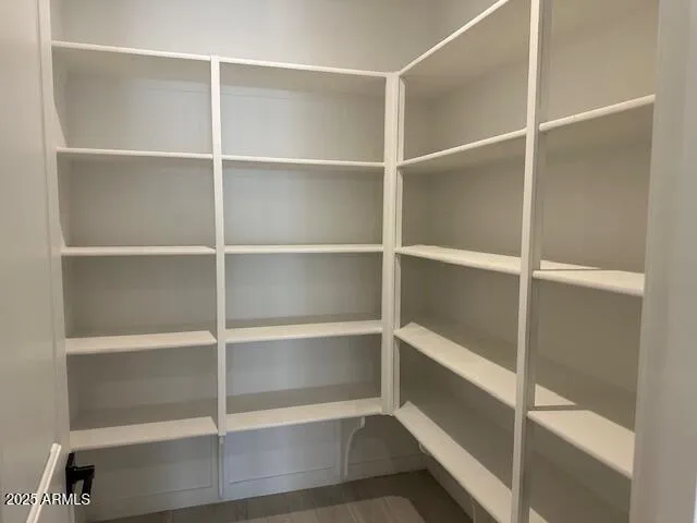 an empty room with a ceiling fan and window