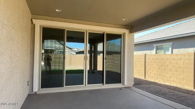 a kitchen with a sink chandelier and wooden floor