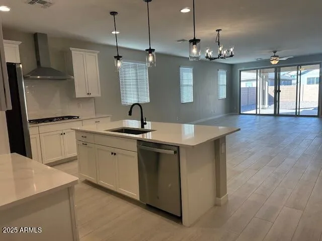 a large kitchen with kitchen island a sink stainless steel appliances and cabinets