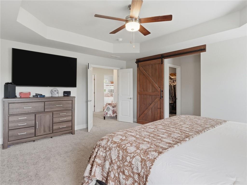 147 Fieldbrook Crossing Canton, GA 30115 - Photo 21 of 46 a bedroom with a bed and a flat screen tv