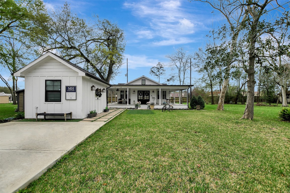 a front view of a house with yard and green space