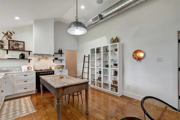 a kitchen with a wooden floor and white appliances