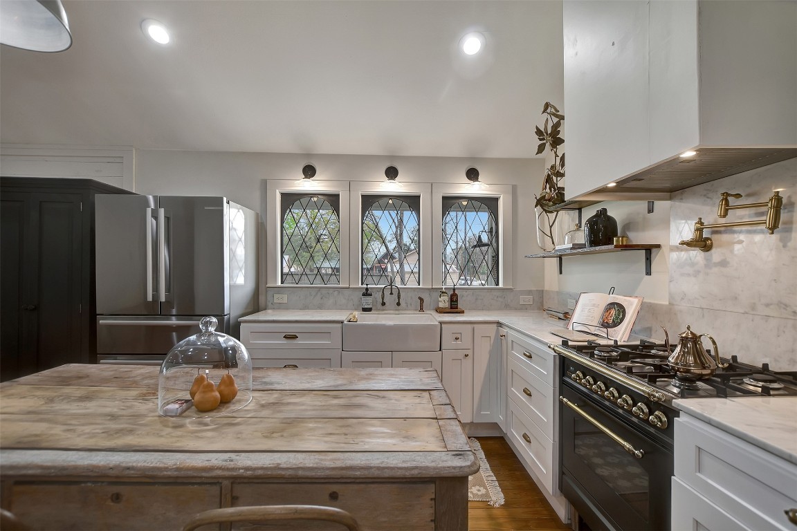 507 Mason Street Tomball, TX 77375 - Photo 12 of 24 a kitchen with a stove and a refrigerator