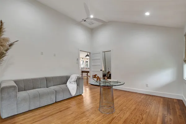 a living room with furniture and a wooden floor