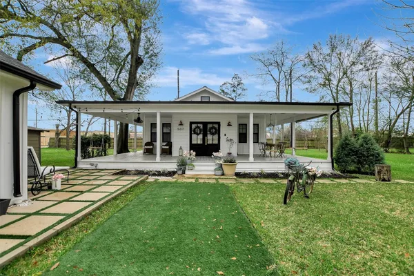 a view of a house with backyard porch and sitting area